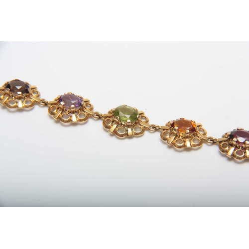 710 - A 9CT GOLD FILIGREE MULTI-COLOURED STONES BRACELET 17.5cm across