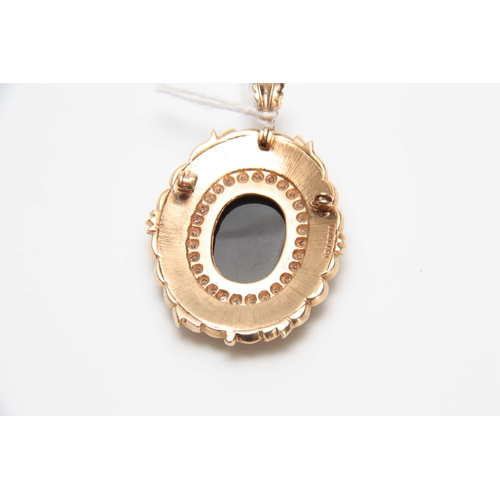 726 - .375 HALLMARKED YELLOW GOLD OVAL CAMEO PENDANT with diamond set border on a matted ground with leaf ... 