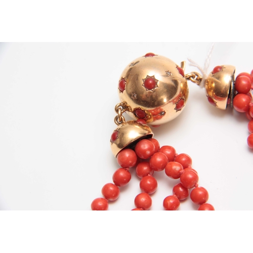 728 - AN 18CT YELLOW GOLD AND MULTI STRING CORAL BEAD NECKLACE with diamond star-spangled ball fastener an... 