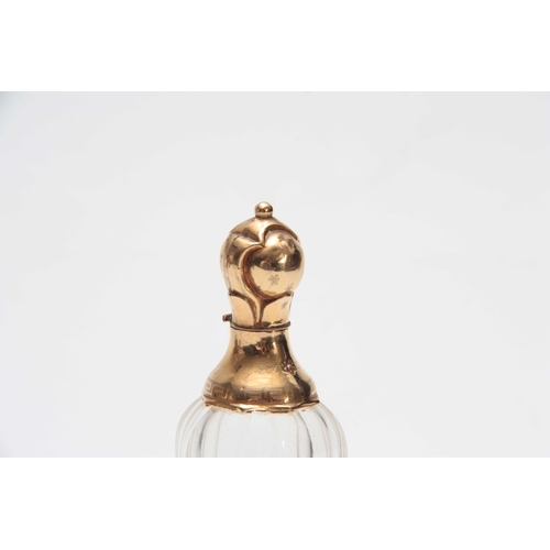 735 - AN 18CT GOLD MOUNTED PERFUME BOTTLE with tapering faceted clear body, florally embossed foot and sho... 