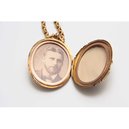 737 - A VICTORIAN LARGE OVAL LOCKET  AND NECK CHAIN - tested as 15ct Gold, the front with diagonal hatched... 