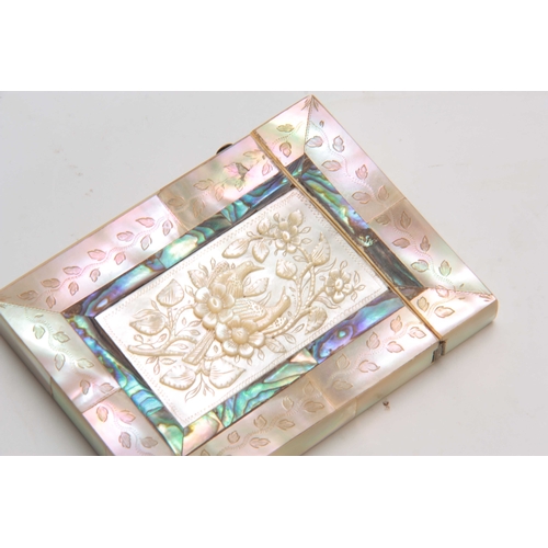 739 - A 19TH CENTURY TWO-TONE MOTHER OF PEARL ENGRAVED CARD CASE with flower head carved relief panel to t... 