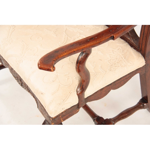 1001 - A GEO II STAINED BEECH GENTLEMANS IRISH OPEN ARMCHAIR with shaped top rail having carved shell above... 