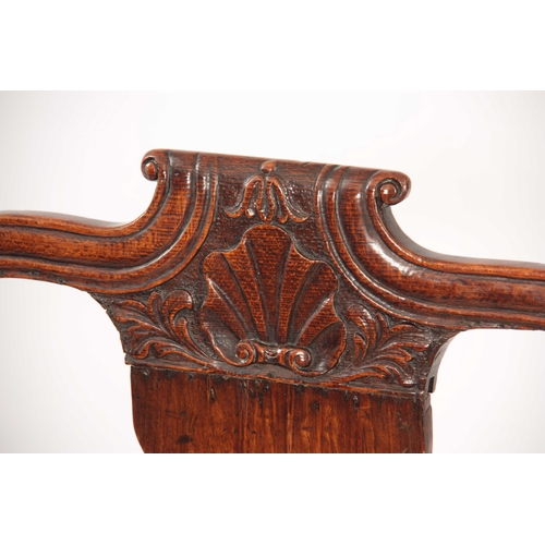 1001 - A GEO II STAINED BEECH GENTLEMANS IRISH OPEN ARMCHAIR with shaped top rail having carved shell above... 