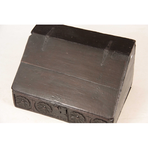 1002 - A LATE 17TH CENTURY OAK DESK BOX with angled fall having strap iron hinges, above a floral flower, c... 