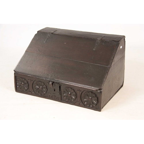 1002 - A LATE 17TH CENTURY OAK DESK BOX with angled fall having strap iron hinges, above a floral flower, c... 