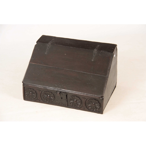 1002 - A LATE 17TH CENTURY OAK DESK BOX with angled fall having strap iron hinges, above a floral flower, c... 