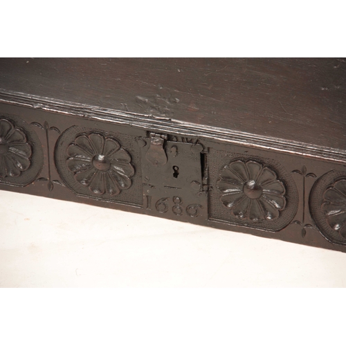 1002 - A LATE 17TH CENTURY OAK DESK BOX with angled fall having strap iron hinges, above a floral flower, c... 