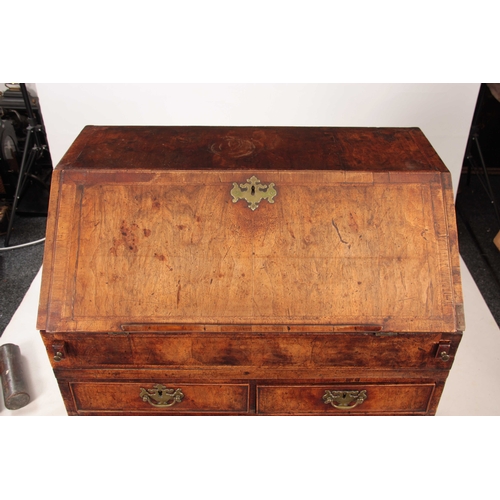 1005 - AN EARLY 18TH CENTURY QUEEN ANNE WALNUT BUREAU HAVING SUPERB ORIGINAL COLOUR AND PATINA the hinged a... 