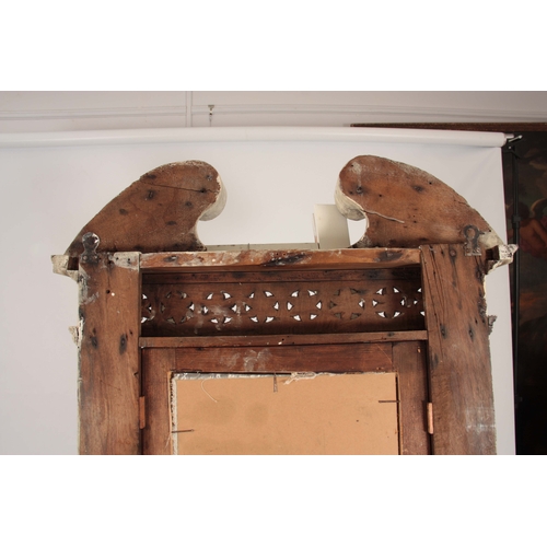 1011 - A GEORGE III CARVED PAINTED PINE HANGING MIRROR IN THE MANER OF FRANCIS AND JOHN BOOKER OF DUBLIN of... 