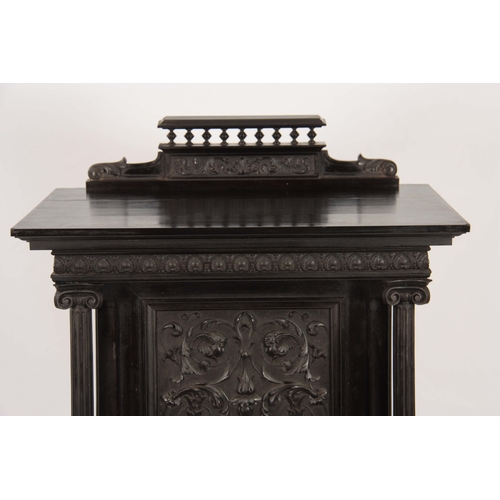 1018 - AN UNUSUAL 19TH CENTURY FRENCH EBONISED COLLECTORS CABINET with finely carved columns and hinged doo... 