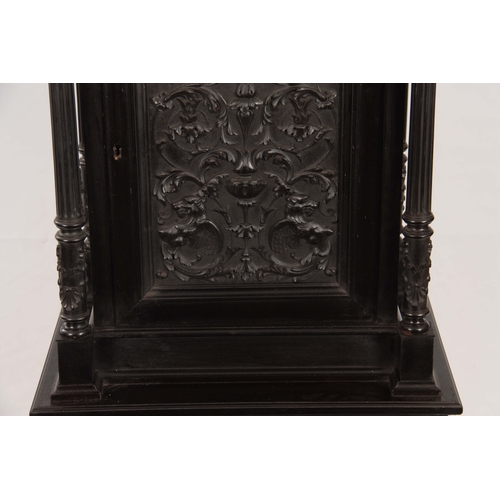 1018 - AN UNUSUAL 19TH CENTURY FRENCH EBONISED COLLECTORS CABINET with finely carved columns and hinged doo... 