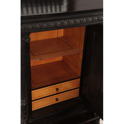 1018 - AN UNUSUAL 19TH CENTURY FRENCH EBONISED COLLECTORS CABINET with finely carved columns and hinged doo... 