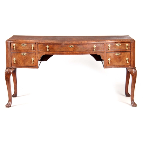 1025 - A 19TH CENTURY QUEEN ANNE STYLE FIGURED WALNUT SERPENTINE FRONTED DESK with a short-grained moulded ... 