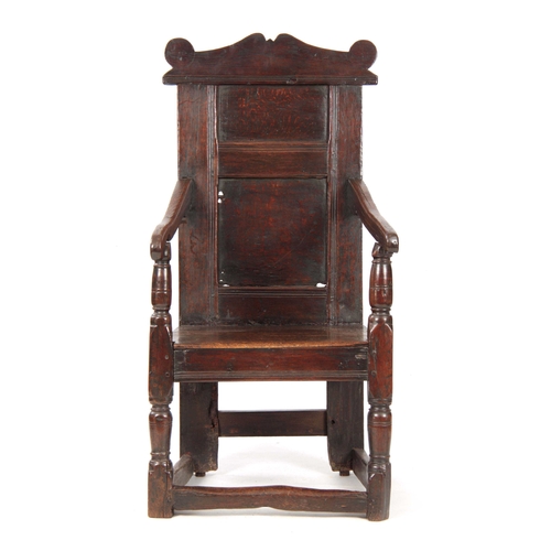 1029 - A 17TH CENTURY JOINED OAK WAINSCOTT CHAIR with a shaped top rail, above a panelled back with swept o... 