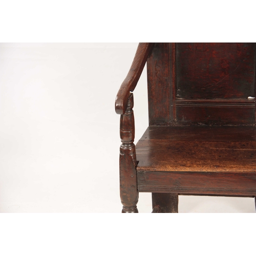 1029 - A 17TH CENTURY JOINED OAK WAINSCOTT CHAIR with a shaped top rail, above a panelled back with swept o... 