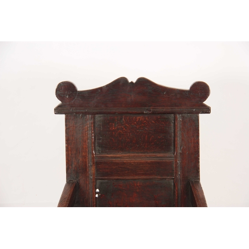 1029 - A 17TH CENTURY JOINED OAK WAINSCOTT CHAIR with a shaped top rail, above a panelled back with swept o... 