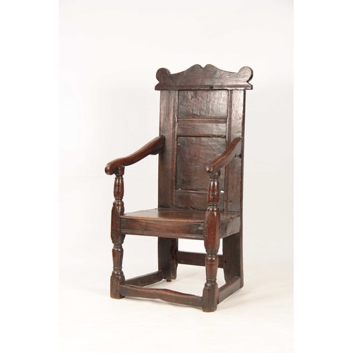 1029 - A 17TH CENTURY JOINED OAK WAINSCOTT CHAIR with a shaped top rail, above a panelled back with swept o... 