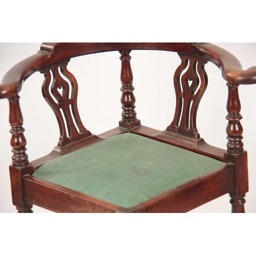 1031 - A GEORGE II WALNUT CORNER CHAIR with shaped back having pierced back splats raised by turned support... 