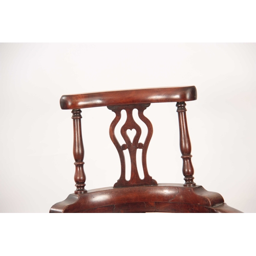 1031 - A GEORGE II WALNUT CORNER CHAIR with shaped back having pierced back splats raised by turned support... 