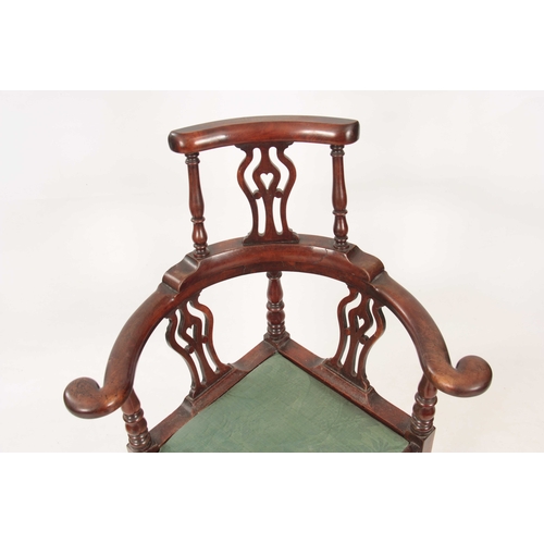 1031 - A GEORGE II WALNUT CORNER CHAIR with shaped back having pierced back splats raised by turned support... 