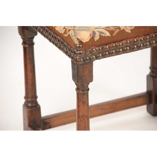 1038 - A RARE LATE 17TH CENTURY OAK UPHOLSTERED JOINT STOOL with tapestry top; standing on ring turned supp... 