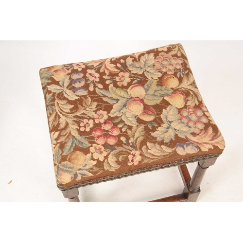 1038 - A RARE LATE 17TH CENTURY OAK UPHOLSTERED JOINT STOOL with tapestry top; standing on ring turned supp... 