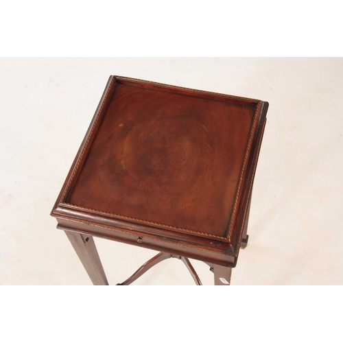 1045 - A GEORGE III FIGURED MAHOGANY KETTLESTAND the square top with chequer banded moulded edge above a pu... 