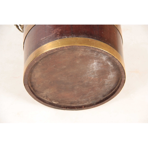 1050 - A GEORGE III MAHOGANY CIRCULAR BRASS BOUND PEAT BUCKET with ringed brass hoops and side carrying han... 