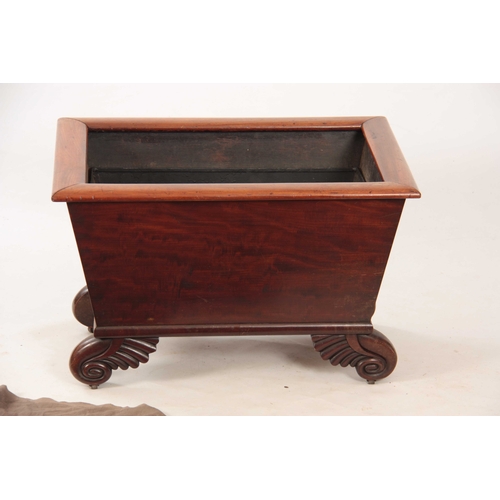 1058 - A WILLIAM IV MAHOGANY WINE COOLER with rounded moulded edge above tapering sides; mounted on leaf ca... 