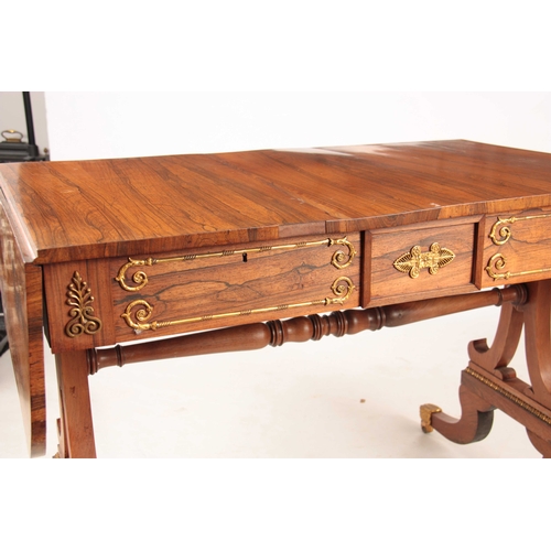 1060 - A REGENCY ROSEWOOD SOFA TABLE with gilded brass mounts, the top with fall down leaves and frieze dra... 