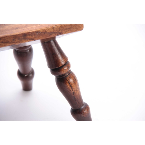 1067 - A 19TH CENTURY ELM STOOL with thick-cut chamfered top and four ring-turned leg supports 22cm wide 18... 