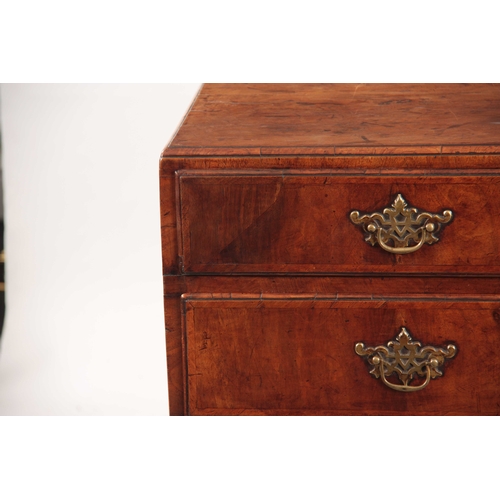 1080 - A GEORGE I WALNUT CHEST OF DRAWERS with a caddy moulded top above four graduated drawers fitted with... 