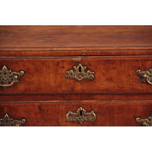 1080 - A GEORGE I WALNUT CHEST OF DRAWERS with a caddy moulded top above four graduated drawers fitted with... 