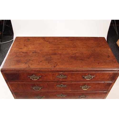 1080 - A GEORGE I WALNUT CHEST OF DRAWERS with a caddy moulded top above four graduated drawers fitted with... 