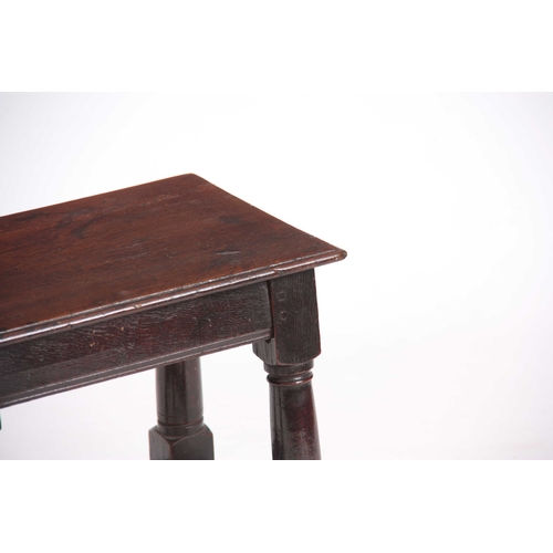 1082 - A LATE 17TH CENTURY OAK JOINT STOOL with plank top above ring turned legs joined by under stretchers... 