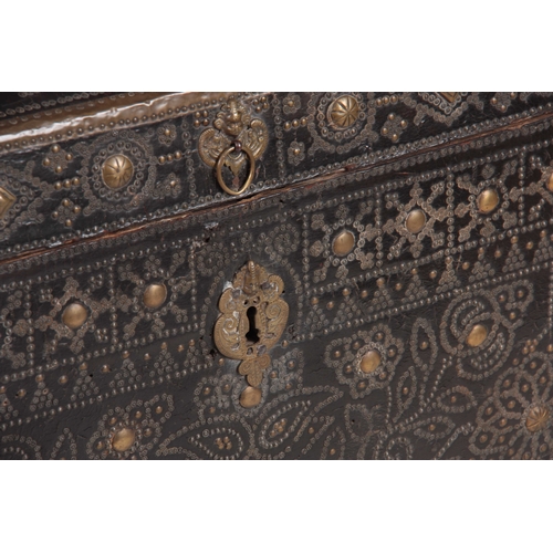 1086 - A LATE 17TH CENTURY BRASS STUDDED DOME TOPPED LEATHER TRUNK decorated with tulips and scrolled leaf ... 