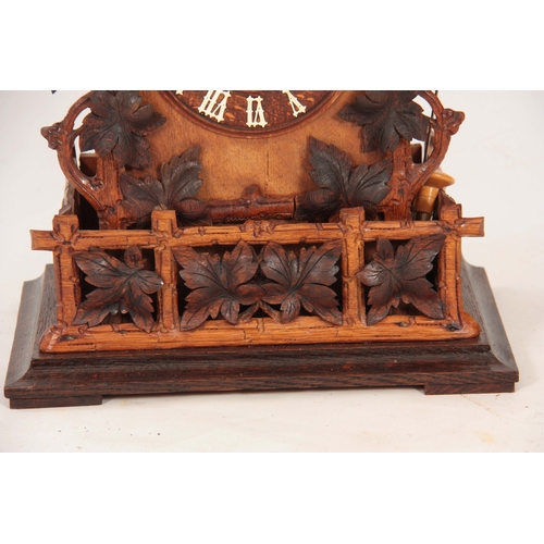 875 - A LATE 19th CENTURY BLACK FOREST CUCKOO CLOCK the architectural pediment with carved leaf decoration... 