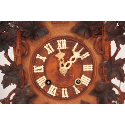 875 - A LATE 19th CENTURY BLACK FOREST CUCKOO CLOCK the architectural pediment with carved leaf decoration... 