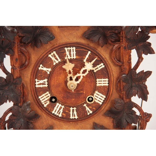 875 - A LATE 19th CENTURY BLACK FOREST CUCKOO CLOCK the architectural pediment with carved leaf decoration... 