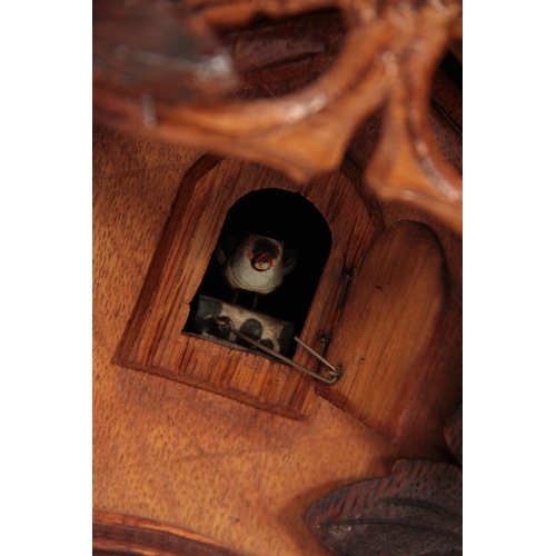 875 - A LATE 19th CENTURY BLACK FOREST CUCKOO CLOCK the architectural pediment with carved leaf decoration... 