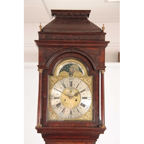 890 - THOMAS OGDEN, HALIFAX. A GEORGE II OAK LONGCASE CLOCK the hood with cady top and blind fret above a ... 