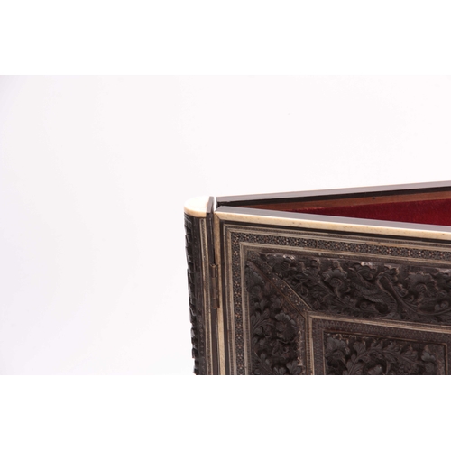 904 - A LATE 19th CENTURY ANGLO-INDIAN CARVED EBONY AND IVORY PRESS shaped in the form of a book with hing... 