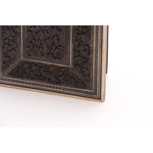 904 - A LATE 19th CENTURY ANGLO-INDIAN CARVED EBONY AND IVORY PRESS shaped in the form of a book with hing... 