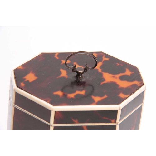 911 - A GEORGE III TORTOISESHELL OCTAGONAL SHAPED TEA CADDY with ivory edges and shield-shaped plaque and ... 