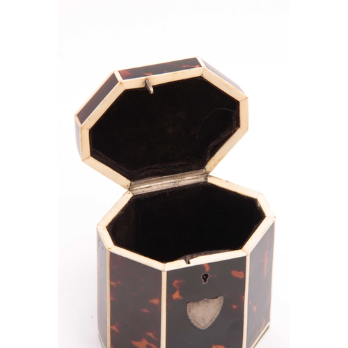 911 - A GEORGE III TORTOISESHELL OCTAGONAL SHAPED TEA CADDY with ivory edges and shield-shaped plaque and ... 