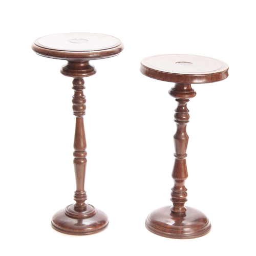 926 - TWO 19TH CENTURY WALNUT WIGSTANDS having ringed tops above turned column supports standing on domed ... 