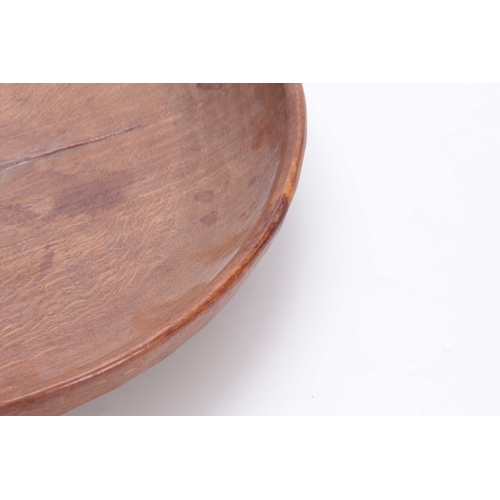 932 - A ROBERT MOUSEMAN THOMPSON OAK FRUIT BOWL of shallow adzed circular form with central high relief ca... 