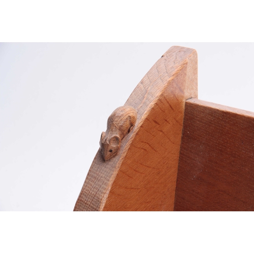 934 - A ROBERT MOUSEMAN THOMPSON OAK BOOK TROUGH of adzed form with curved ends and carved mouse trademark... 