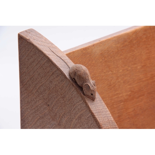 934 - A ROBERT MOUSEMAN THOMPSON OAK BOOK TROUGH of adzed form with curved ends and carved mouse trademark... 